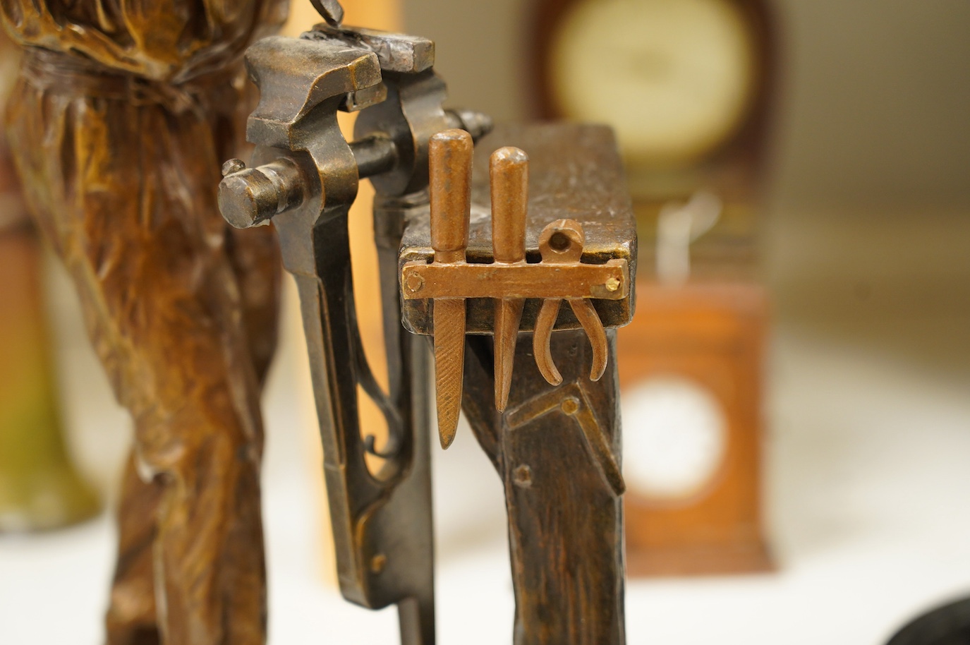 A large bronze of a blacksmith and work bench, signed Carlier, 42cm high. Condition - good